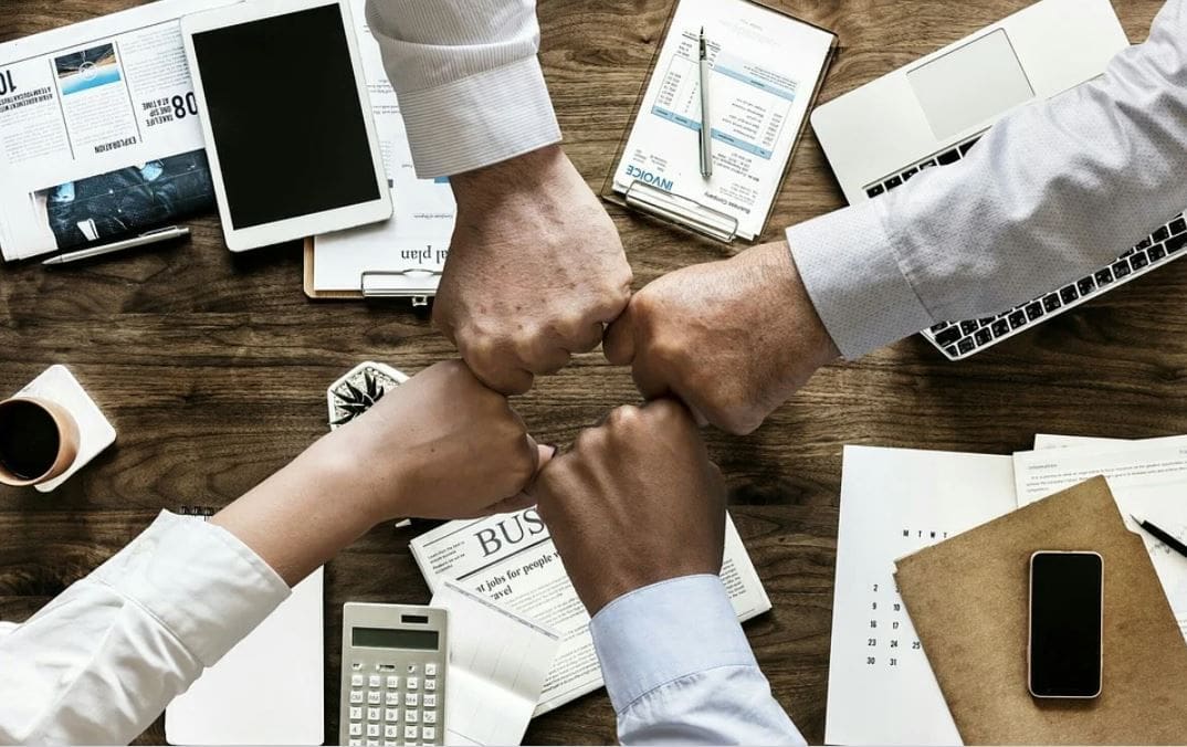 Creating Business Partnerships 1 bumping fists over a table